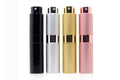Compact refillable travel perfume atomizer with sleek metal body and anodized aluminum nozzle in multiple colors.